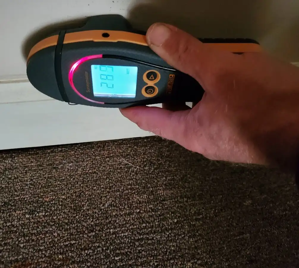 Moisture detection at baseboard during Storm Damage Restoration in Beloit